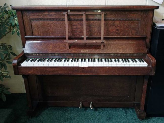 Piano rental W J Parkes & Co upright piano in an oak finish