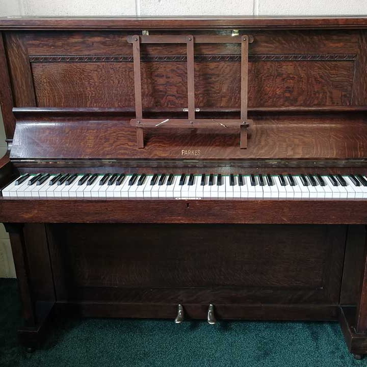Piano rental W J Parkes & Co upright piano in an oak finish